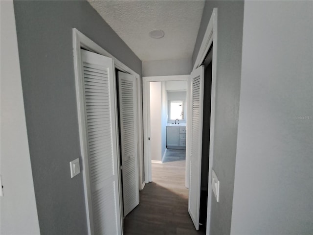 26 Clintwood Ave, Englewood, FL 34223 - hall featuring a textured ceiling and dark wood-style flooring
