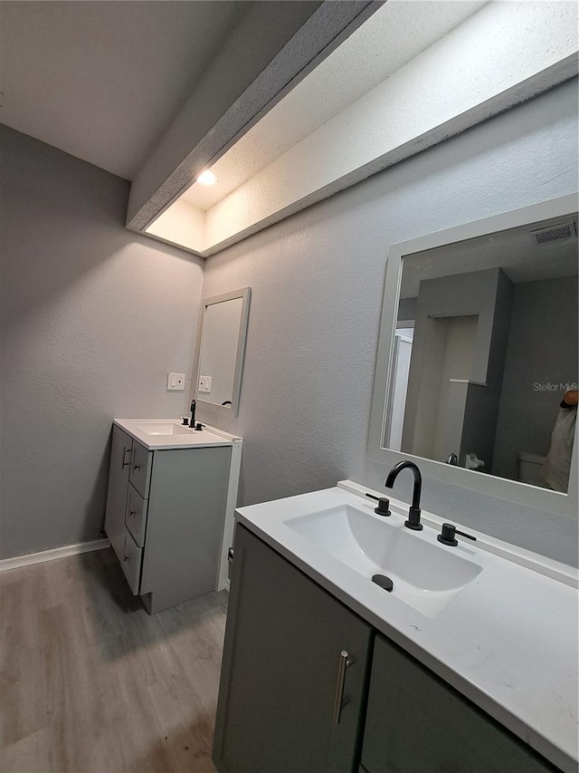 26 Clintwood Ave, Englewood, FL 34223 - bathroom with two vanities and wood finished floors
