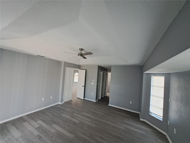 26 Clintwood Ave, Englewood, FL 34223 - unfurnished living room with dark wood-style flooring, a ceiling fan, and a textured ceiling