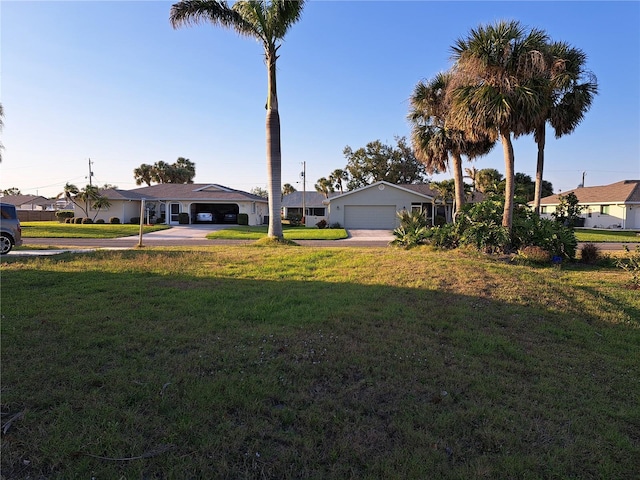 26 Clintwood Ave, Englewood, FL 34223 - view of front of house featuring driveway, a front yard, a residential view, and a carport