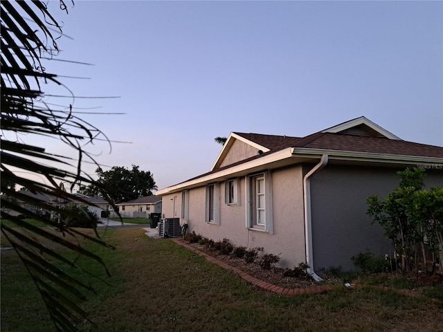 26 Clintwood Ave, Englewood, FL 34223 - property exterior at dusk with stucco siding, a yard, and roof with shingles