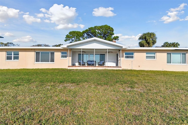 116 Shore Drive Pl, Oldsmar, FL 34677 - rear view of house with a lawn, ceiling fan, and stucco siding