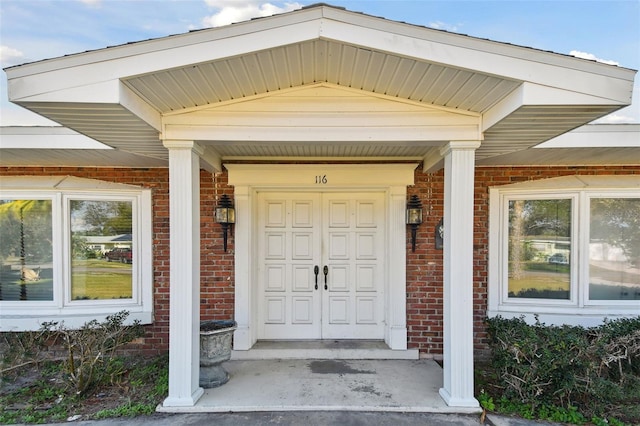 116 Shore Drive Pl, Oldsmar, FL 34677 - property entrance with a porch and brick siding