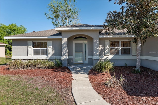 4575 NW 30th Pl, Ocala, FL 34482 - ranch-style home with a shingled roof and stucco siding