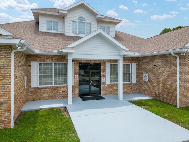 4575 NW 30th Pl, Ocala, FL 34482 - entrance to property featuring brick siding and roof with shingles