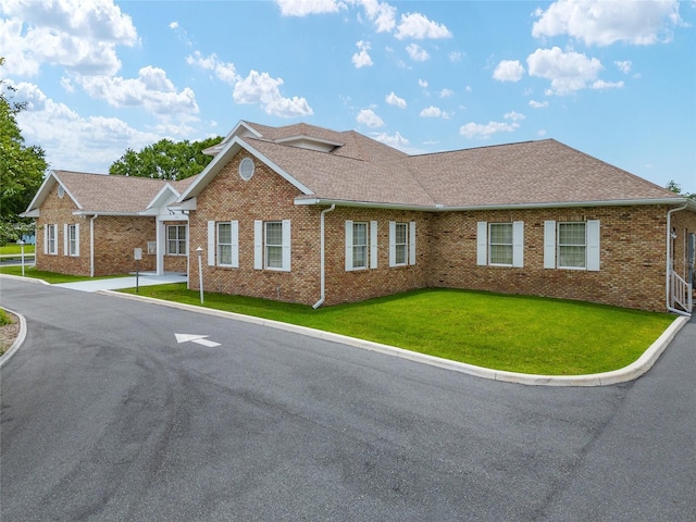 4575 NW 30th Pl, Ocala, FL 34482 - ranch-style house with brick siding, a front lawn, and roof with shingles
