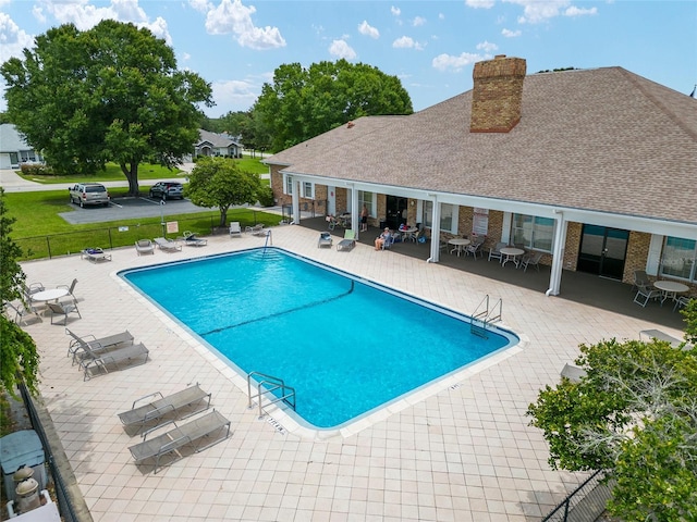 4575 NW 30th Pl, Ocala, FL 34482 - community pool with a lawn, fence, and a patio