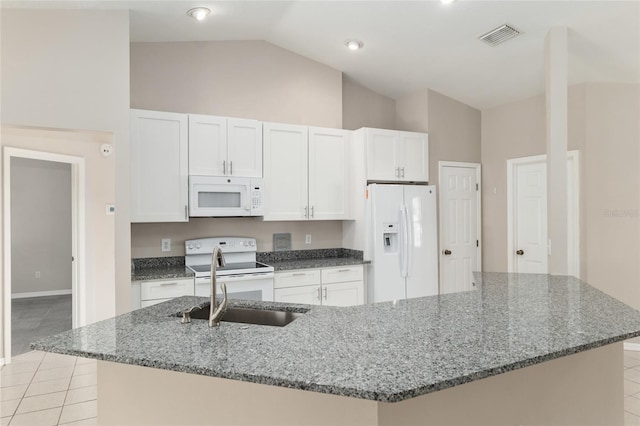 4575 NW 30th Pl, Ocala, FL 34482 - kitchen featuring a large island with sink, vaulted ceiling, white appliances, visible vents, and white cabinets