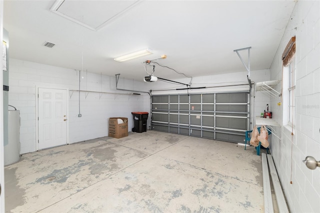 4575 NW 30th Pl, Ocala, FL 34482 - garage featuring water heater, concrete block wall, and a garage door opener