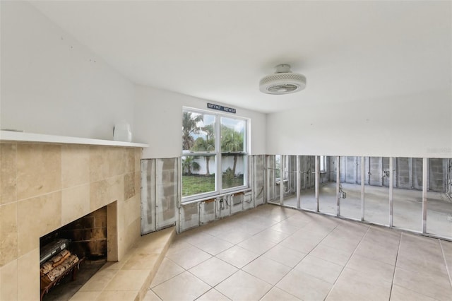 104 Carlyle Cir, Palm Harbor, FL 34683 - unfurnished living room with a fireplace, tile patterned floors, and tile walls