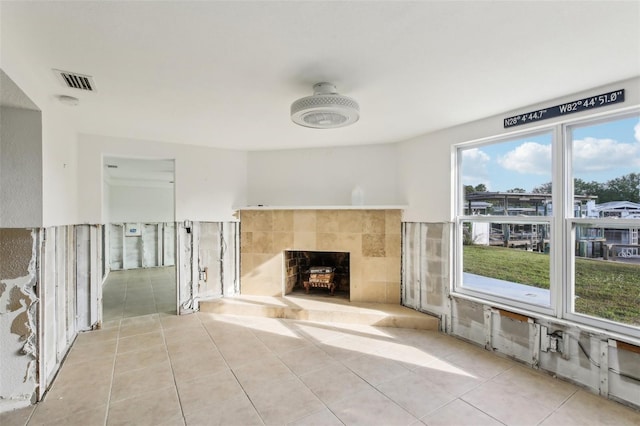 104 Carlyle Cir, Palm Harbor, FL 34683 - unfurnished living room with a tile fireplace and tile patterned floors