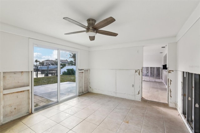 104 Carlyle Cir, Palm Harbor, FL 34683 - unfurnished room with a ceiling fan, light tile patterned flooring, ornamental molding, and a water view