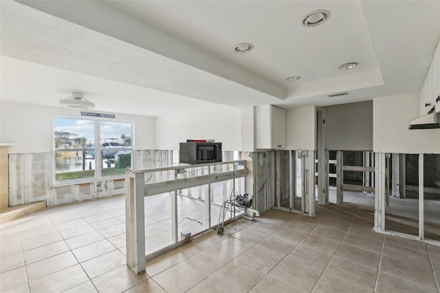 104 Carlyle Cir, Palm Harbor, FL 34683 - hallway featuring light tile patterned floors, a water view, and a raised ceiling