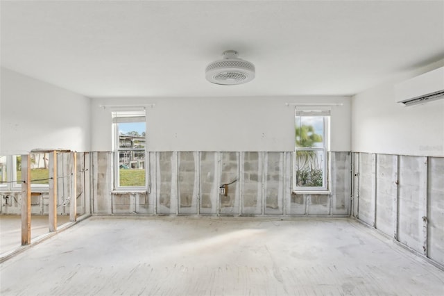 104 Carlyle Cir, Palm Harbor, FL 34683 - spare room with a wall mounted air conditioner and concrete flooring