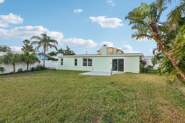 104 Carlyle Cir, Palm Harbor, FL 34683 - back of property with stucco siding, a patio area, and a chimney
