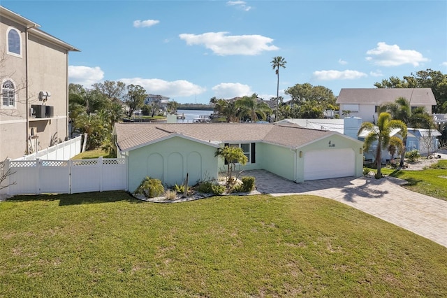104 Carlyle Cir, Palm Harbor, FL 34683 - view of front facade featuring an attached garage, decorative driveway, and a water view