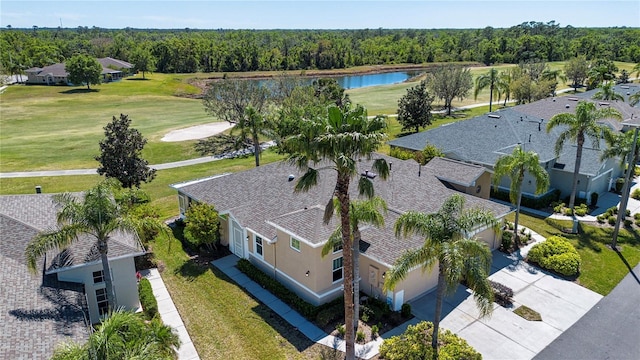 drone / aerial view with a water view and a forest view