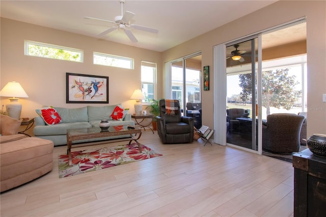 living room with wood finished floors and a ceiling fan
