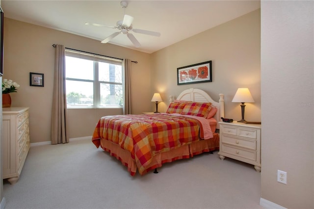 bedroom with baseboards, light colored carpet, and ceiling fan