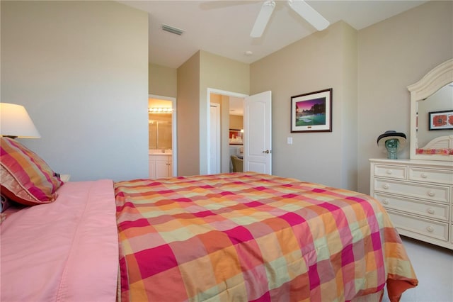 carpeted bedroom featuring ensuite bathroom, ceiling fan, and visible vents