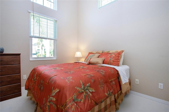 bedroom featuring baseboards and carpet flooring