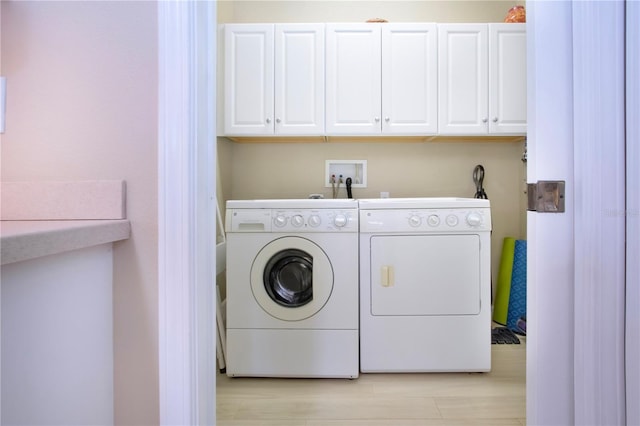 laundry area with cabinet space and separate washer and dryer