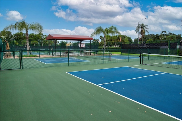 view of sport court featuring fence