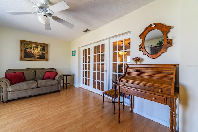 5427 Springwood Blvd Unit 5427, Pinellas Park, FL 33782 - sitting room with visible vents, wood finished floors, ceiling fan, a textured ceiling, and french doors