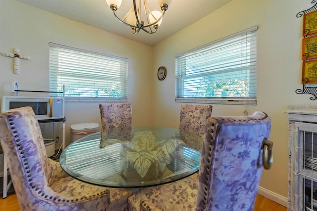 5427 Springwood Blvd Unit 5427, Pinellas Park, FL 33782 - dining space with an inviting chandelier and wood finished floors