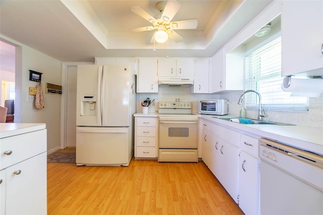 5427 Springwood Blvd Unit 5427, Pinellas Park, FL 33782 - kitchen with white appliances, a tray ceiling, under cabinet range hood, and a sink