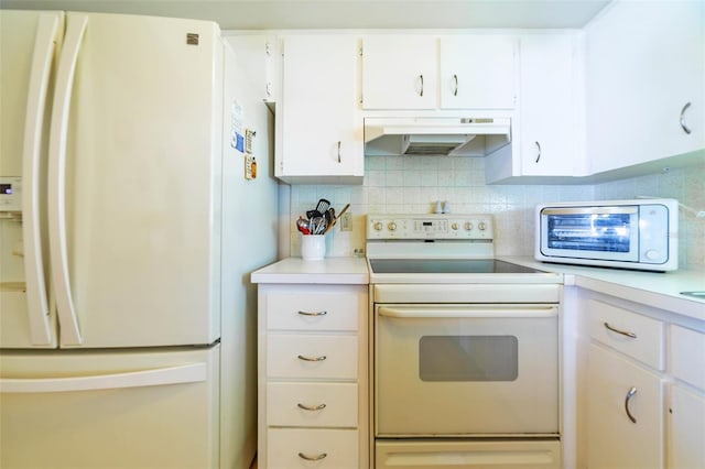 5427 Springwood Blvd Unit 5427, Pinellas Park, FL 33782 - kitchen featuring decorative backsplash, white appliances, light countertops, under cabinet range hood, and white cabinets
