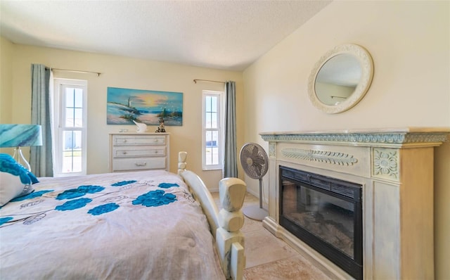 5427 Springwood Blvd Unit 5427, Pinellas Park, FL 33782 - bedroom featuring a textured ceiling, a glass covered fireplace, and multiple windows