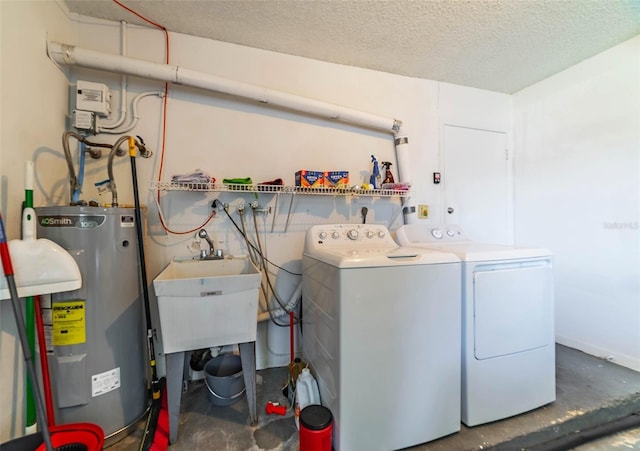 5427 Springwood Blvd Unit 5427, Pinellas Park, FL 33782 - clothes washing area featuring laundry area, a textured ceiling, washing machine and dryer, and electric water heater