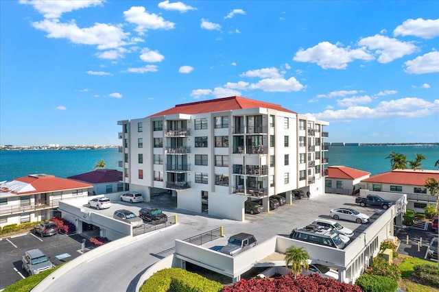 exterior space with a water view and uncovered parking