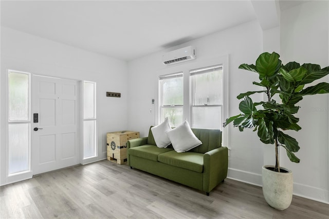 819 11th St N, Saint Petersburg, FL 33705 - sitting room featuring wood finished floors, baseboards, and a wall mounted air conditioner