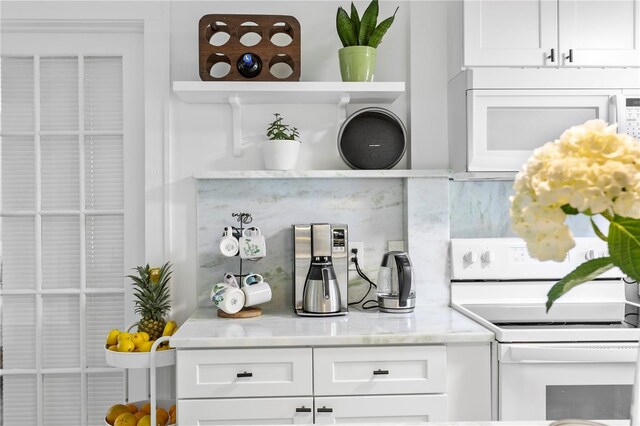 819 11th St N, Saint Petersburg, FL 33705 - kitchen featuring open shelves, white appliances, tasteful backsplash, and white cabinetry