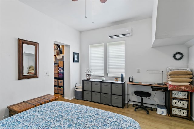 819 11th St N, Saint Petersburg, FL 33705 - bedroom featuring a wall mounted air conditioner, wood finished floors, and ceiling fan