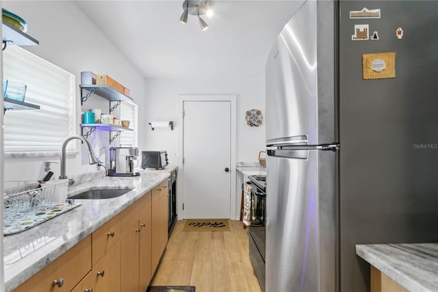 819 11th St N, Saint Petersburg, FL 33705 - kitchen featuring light wood-type flooring, a sink, open shelves, freestanding refrigerator, and black / electric stove