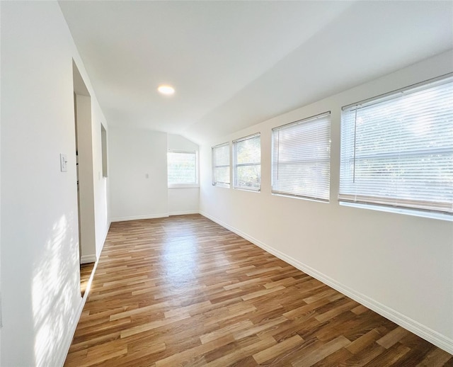 819 11th St N, Saint Petersburg, FL 33705 - unfurnished room with lofted ceiling, baseboards, and light wood-type flooring