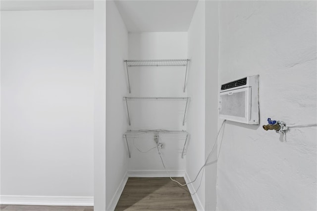 819 11th St N, Saint Petersburg, FL 33705 - spacious closet with a wall mounted air conditioner and wood finished floors