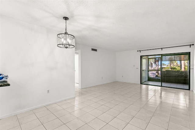 2650 Countryside Blvd Unit B102, Clearwater, FL 33761 - empty room with an inviting chandelier, a textured ceiling, and visible vents