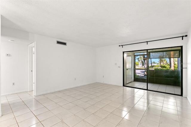 2650 Countryside Blvd Unit B102, Clearwater, FL 33761 - spare room featuring a textured ceiling, light tile patterned floors, and visible vents