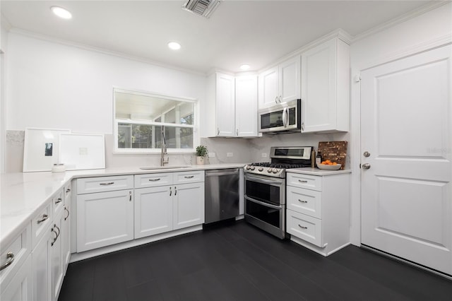 kitchen featuring a sink, light countertops, stainless steel appliances, white cabinetry, and visible vents