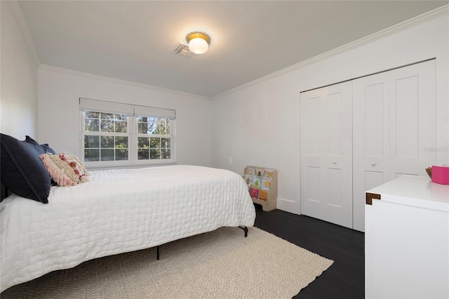 bedroom featuring a closet, visible vents, ornamental molding, and dark wood-type flooring