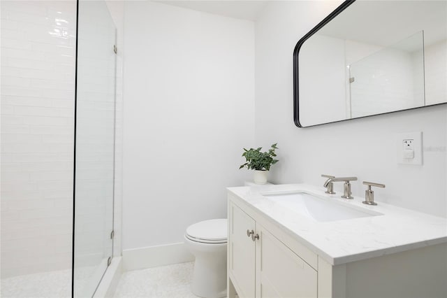 bathroom featuring a tile shower, tile patterned flooring, vanity, toilet, and baseboards