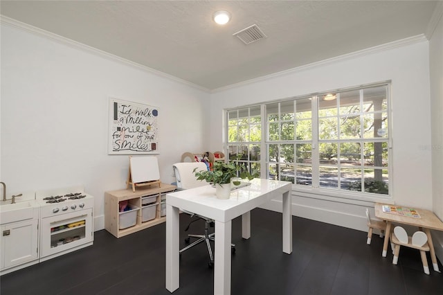 office area featuring crown molding, baseboards, dark wood-type flooring, and visible vents