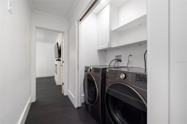 laundry area featuring crown molding, dark wood-style flooring, cabinet space, baseboards, and washing machine and dryer