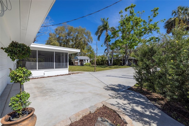view of patio featuring a sunroom