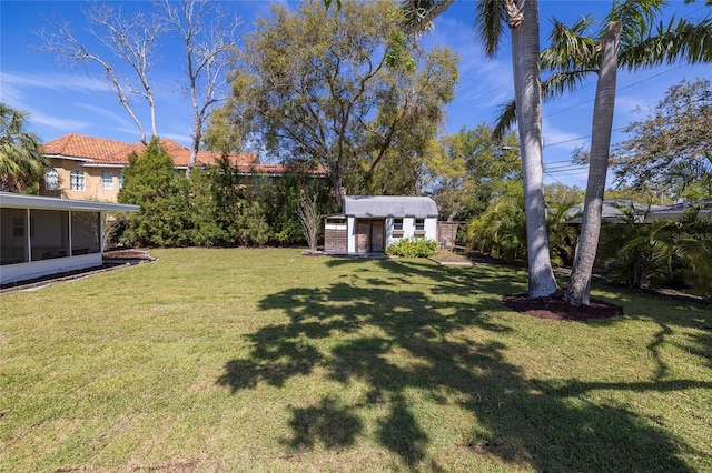view of yard with an outdoor structure and a sunroom