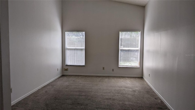 carpeted empty room with baseboards